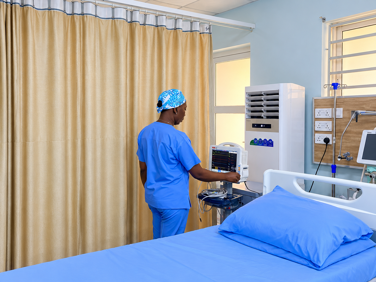 TAC Care nurse monitoring a patient care bed
